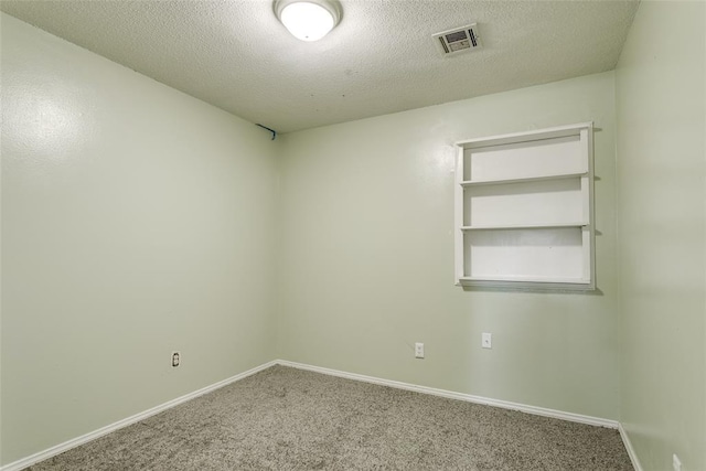601 Woodland Way, Oklahoma City, OK 73127 - empty room with carpet floors and a textured ceiling