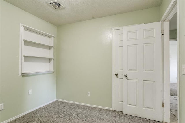 601 Woodland Way, Oklahoma City, OK 73127 - unfurnished bedroom with carpet flooring and a textured ceiling