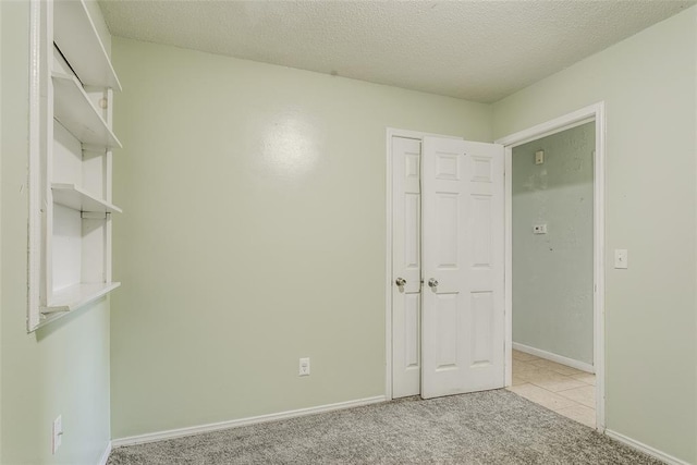 601 Woodland Way, Oklahoma City, OK 73127 - unfurnished bedroom featuring carpet and a textured ceiling