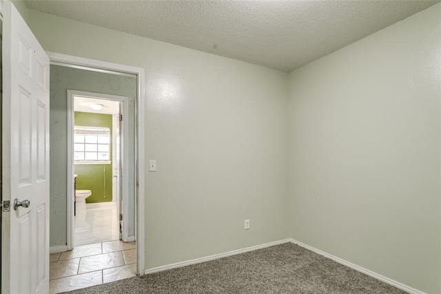 601 Woodland Way, Oklahoma City, OK 73127 - spare room with a textured ceiling and baseboards