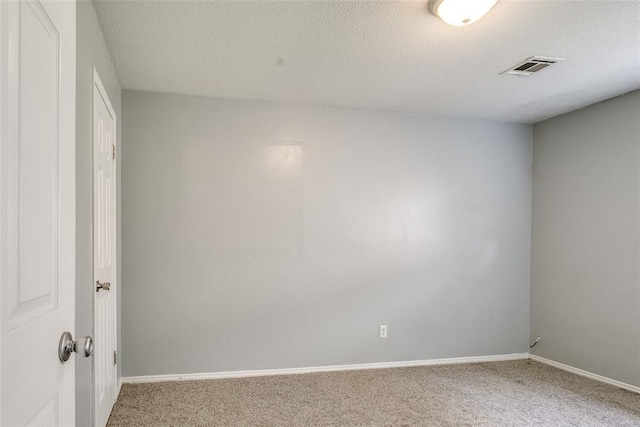 601 Woodland Way, Oklahoma City, OK 73127 - spare room featuring carpet floors and a textured ceiling