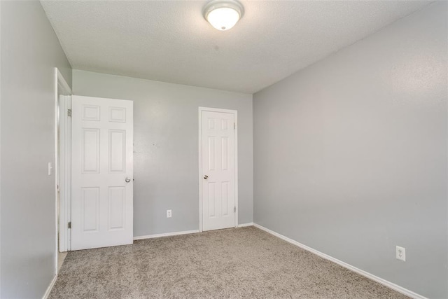 601 Woodland Way, Oklahoma City, OK 73127 - unfurnished bedroom with carpet and a textured ceiling