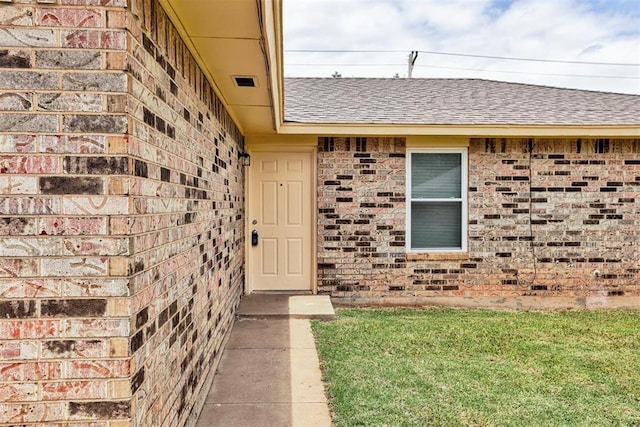 1633 SE 52nd St, Oklahoma City, OK 73129 - doorway to property with brick siding, roof with shingles, and a yard