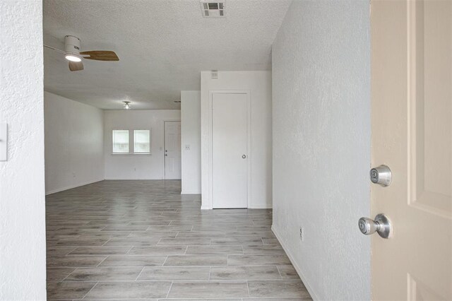1633 SE 52nd St, Oklahoma City, OK 73129 - empty room with ceiling fan, a textured ceiling, wood finish floors, baseboards, and a textured wall