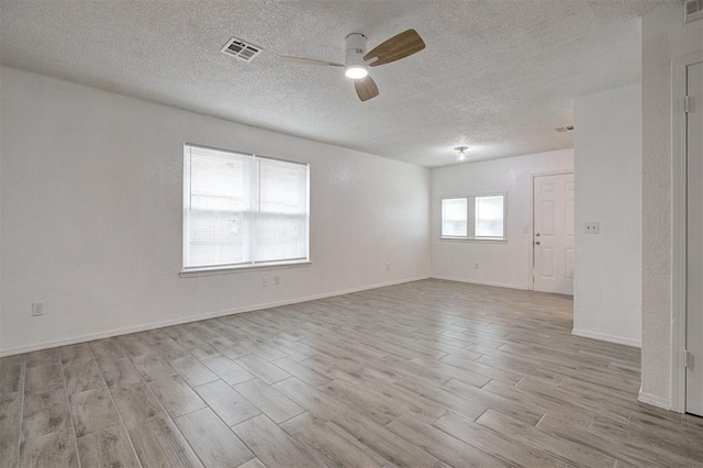 1633 SE 52nd St, Oklahoma City, OK 73129 - unfurnished room featuring a ceiling fan, wood finished floors, a textured ceiling, and baseboards