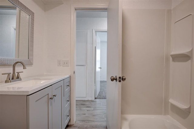 1633 SE 52nd St, Oklahoma City, OK 73129 - full bath featuring wood finished floors, vanity, and bathing tub / shower combination
