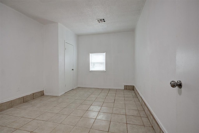 1633 SE 52nd St, Oklahoma City, OK 73129 - empty room featuring a textured ceiling and light tile patterned floors