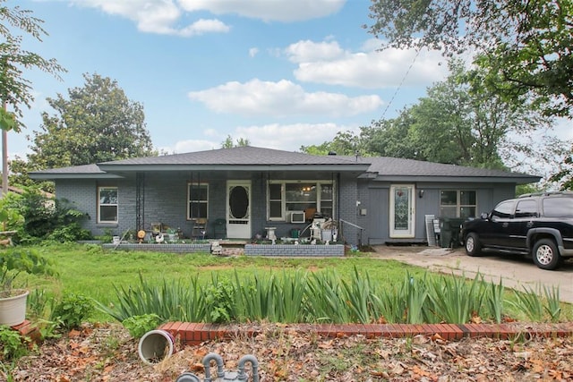 1001 N Pine St, Midwest City, OK 73130 - view of front of house featuring brick siding, a front yard, and covered porch