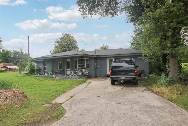 1001 N Pine St, Midwest City, OK 73130 - ranch-style home featuring covered porch, concrete driveway, and a front yard