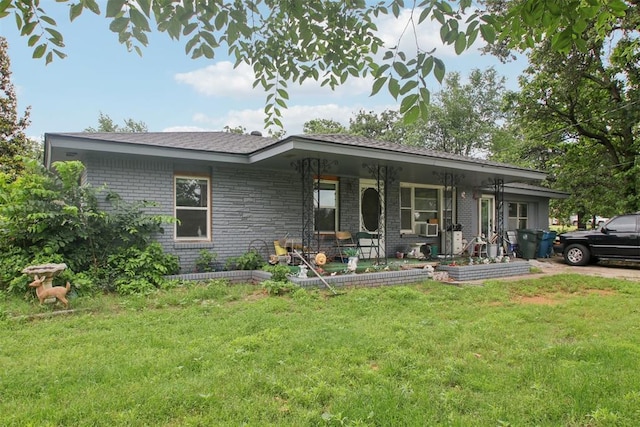 1001 N Pine St, Midwest City, OK 73130 - ranch-style house featuring a front lawn, a porch, brick siding, and cooling unit