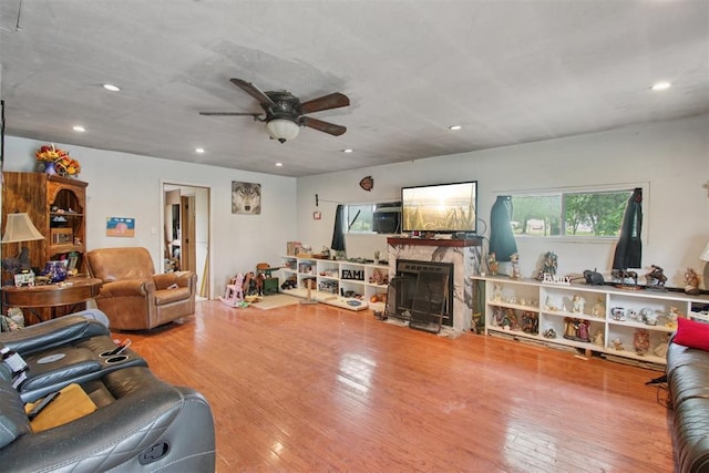 1001 N Pine St, Midwest City, OK 73130 - living area with a ceiling fan, a fireplace with flush hearth, recessed lighting, and wood finished floors