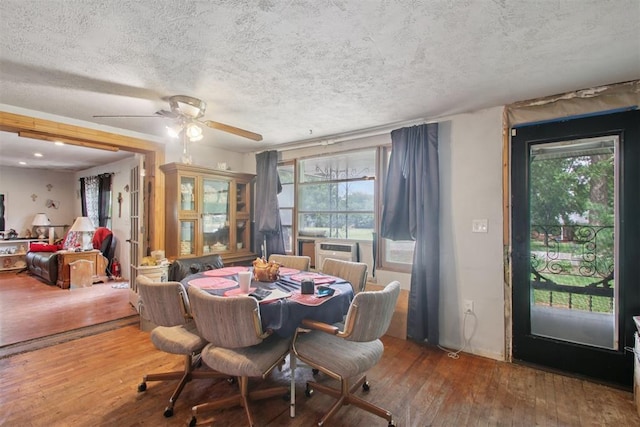 1001 N Pine St, Midwest City, OK 73130 - dining room featuring wood-type flooring, a textured ceiling, and a ceiling fan