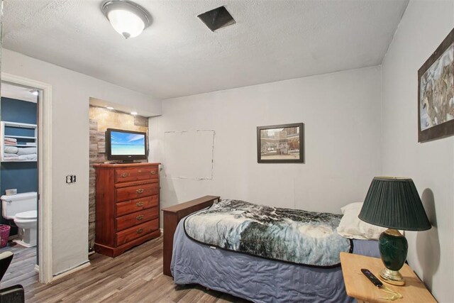 1001 N Pine St, Midwest City, OK 73130 - bedroom featuring wood finished floors