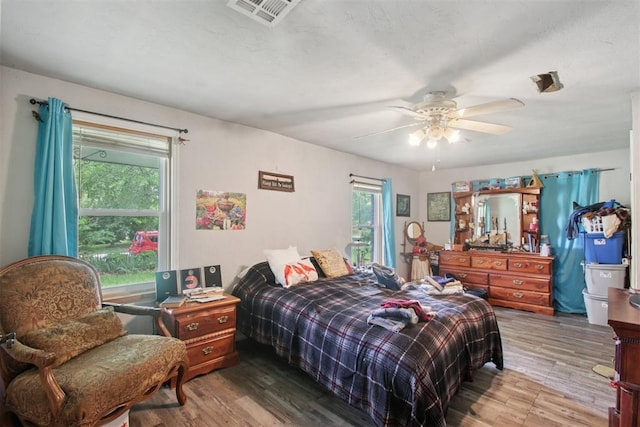 1001 N Pine St, Midwest City, OK 73130 - bedroom with wood finished floors and ceiling fan