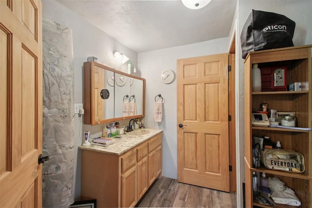 1001 N Pine St, Midwest City, OK 73130 - bathroom with wood finished floors and vanity