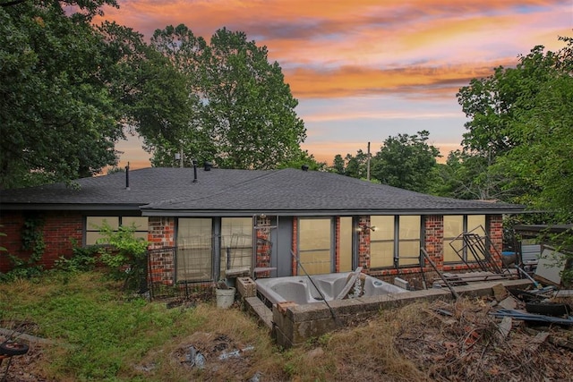 1001 N Pine St, Midwest City, OK 73130 - back of property at dusk with brick siding and a shingled roof