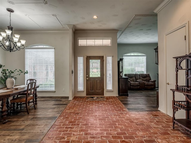 2500 Huntwick Dr, Edmond, OK 73034 - foyer entrance featuring baseboards, ornamental molding, a chandelier, brick patterned floors, and recessed lighting
