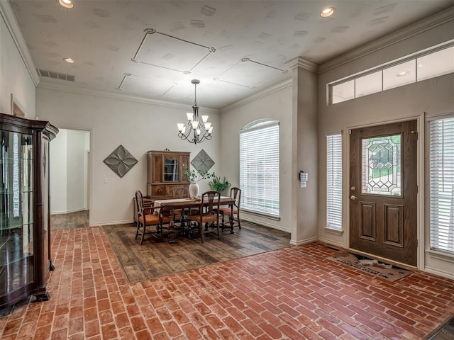 2500 Huntwick Dr, Edmond, OK 73034 - entrance foyer featuring brick flooring, baseboards, a chandelier, plenty of natural light, and ornamental molding