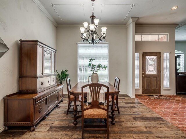 2500 Huntwick Dr, Edmond, OK 73034 - dining space featuring a chandelier, plenty of natural light, ornamental molding, baseboards, and dark wood finished floors