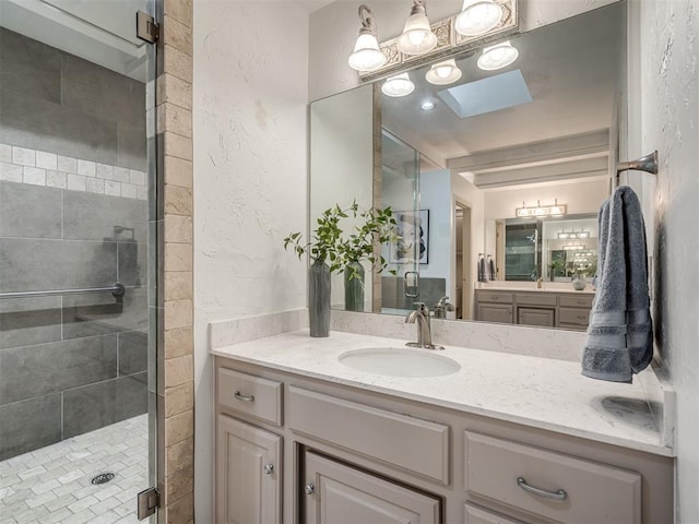 2500 Huntwick Dr, Edmond, OK 73034 - full bathroom with a stall shower, vanity, and a textured wall