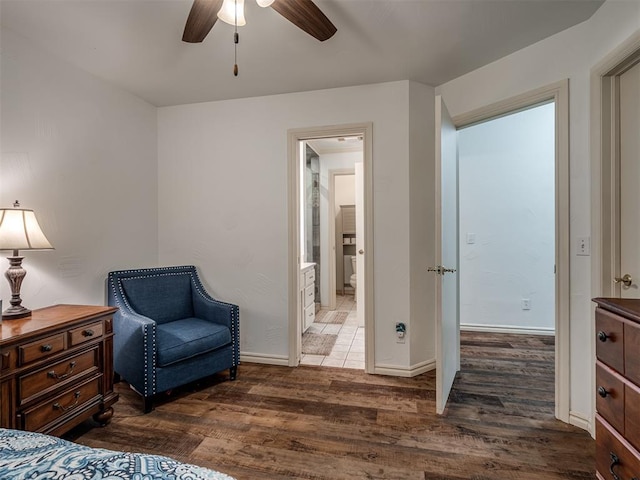 2500 Huntwick Dr, Edmond, OK 73034 - bedroom featuring wood finished floors, baseboards, ensuite bath, and a ceiling fan