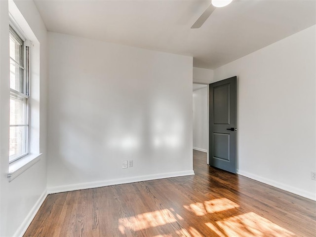 1224 W Brooks St, Norman, OK 73069 - spare room with ceiling fan, wood finished floors, and baseboards