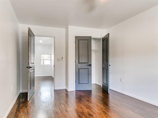 1224 W Brooks St, Norman, OK 73069 - unfurnished bedroom with dark wood-style flooring and baseboards