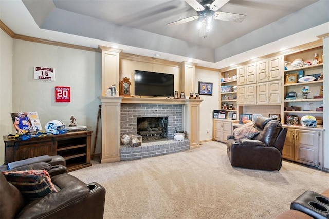 11700 Hackney Ln, Yukon, OK 73099 - living area featuring a tray ceiling, a ceiling fan, light carpet, and a fireplace