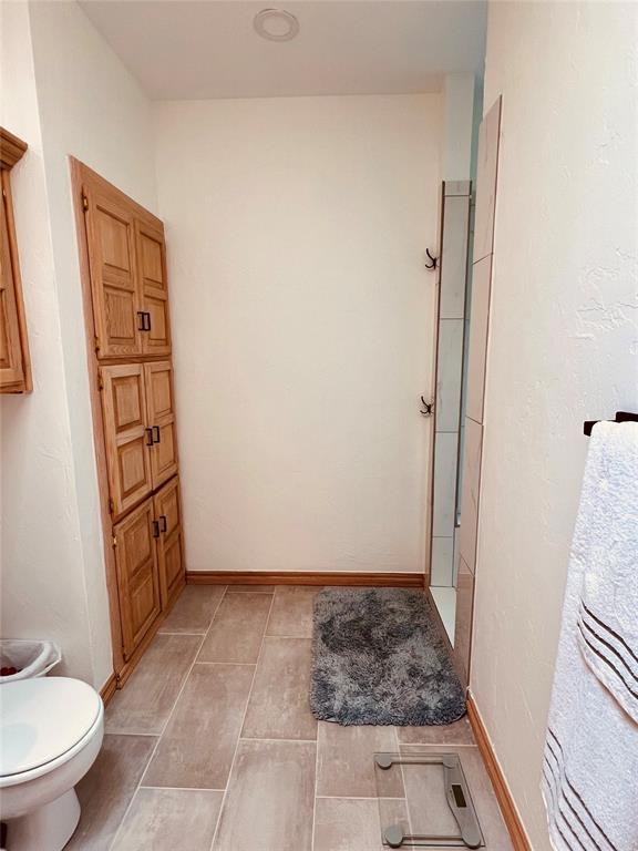 11700 Hackney Ln, Yukon, OK 73099 - full bathroom featuring toilet, baseboards, and tile patterned floors