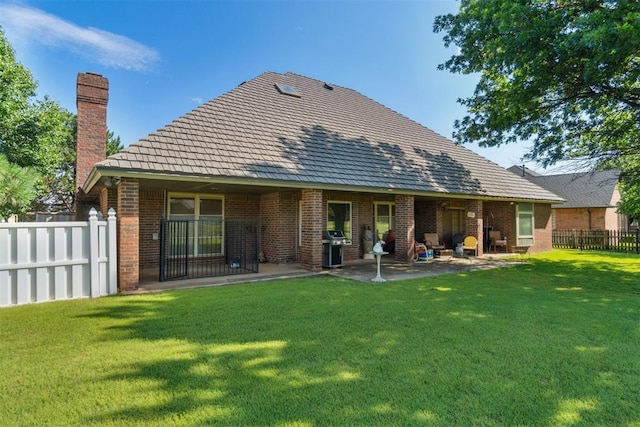 11700 Hackney Ln, Yukon, OK 73099 - back of house featuring a patio, a chimney, and brick siding