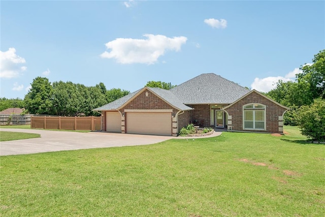 1908 Riviera Dr, Tuttle, OK 73089 - view of front facade featuring a garage, driveway, and brick siding