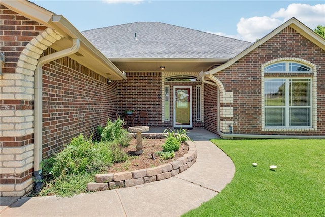 1908 Riviera Dr, Tuttle, OK 73089 - property entrance with brick siding, a shingled roof, and a lawn