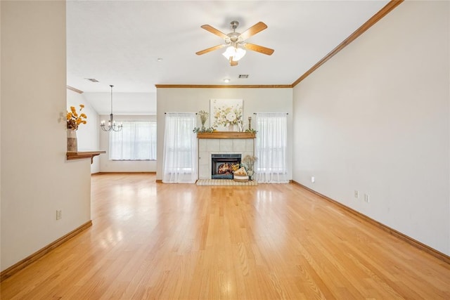 1908 Riviera Dr, Tuttle, OK 73089 - unfurnished living room featuring a tile fireplace, a ceiling fan, baseboards, light wood-type flooring, and ornamental molding