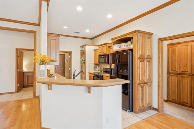 1908 Riviera Dr, Tuttle, OK 73089 - kitchen with black appliances, light wood-type flooring, tasteful backsplash, a peninsula, and a breakfast bar