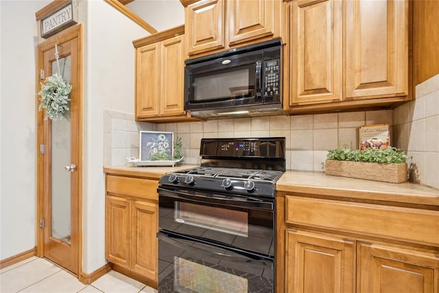 1908 Riviera Dr, Tuttle, OK 73089 - kitchen with black appliances, light countertops, decorative backsplash, and light tile patterned flooring