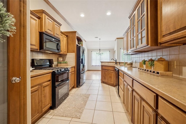 1908 Riviera Dr, Tuttle, OK 73089 - kitchen featuring black appliances, brown cabinetry, light tile patterned floors, tasteful backsplash, and light countertops