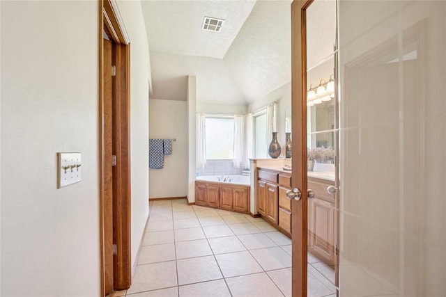 1908 Riviera Dr, Tuttle, OK 73089 - full bathroom with vanity, lofted ceiling, a bath, tile patterned floors, and baseboards