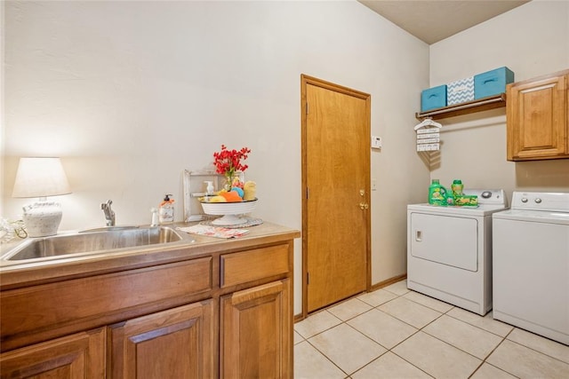 1908 Riviera Dr, Tuttle, OK 73089 - laundry room with washing machine and clothes dryer, a sink, and light tile patterned flooring