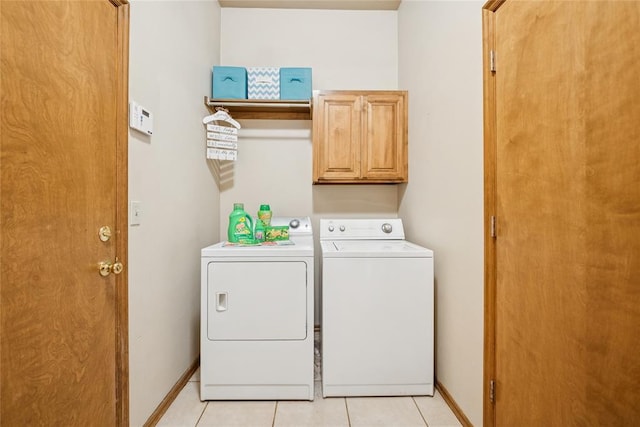 1908 Riviera Dr, Tuttle, OK 73089 - laundry room featuring washing machine and clothes dryer, cabinet space, light tile patterned flooring, and baseboards