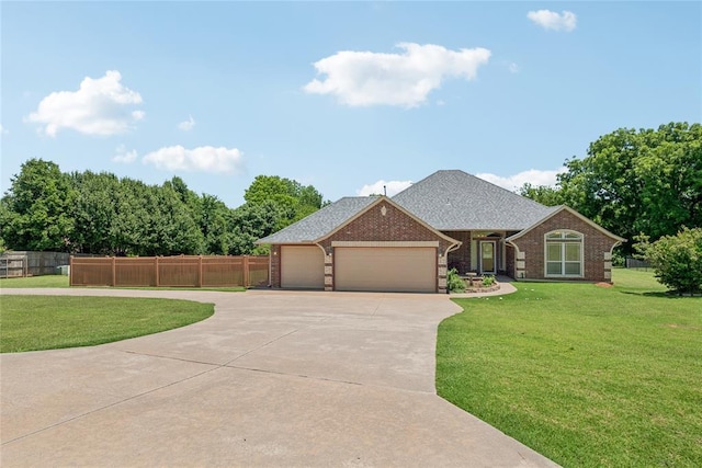 1908 Riviera Dr, Tuttle, OK 73089 - view of front of home featuring driveway, an attached garage, brick siding, and a shingled roof