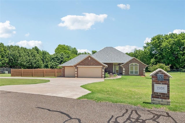 1908 Riviera Dr, Tuttle, OK 73089 - view of front of house featuring a garage, brick siding, and concrete driveway