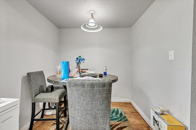 2119 Pearson Dr, Midwest City, OK 73110 - dining room with light wood finished floors and a textured ceiling