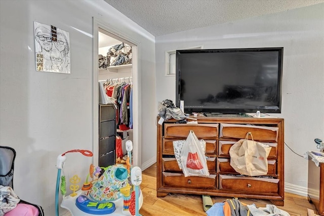 2119 Pearson Dr, Midwest City, OK 73110 - bedroom featuring a textured ceiling, wood finished floors, and a closet
