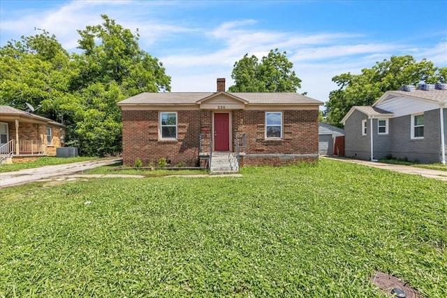 208 E Lockheed Dr, Midwest City, OK 73110 - view of front of house with a front yard, a chimney, brick siding, and a garage
