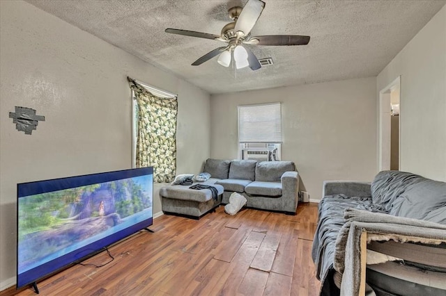 208 E Lockheed Dr, Midwest City, OK 73110 - living area featuring a textured ceiling, hardwood / wood-style floors, ceiling fan, and cooling unit