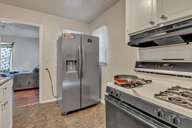 208 E Lockheed Dr, Midwest City, OK 73110 - kitchen with gas range, stainless steel fridge, under cabinet range hood, and plenty of natural light