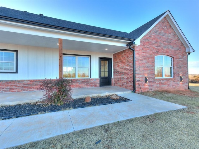 26603 Main St, Blanchard, OK 73010 - view of exterior entry featuring brick siding, board and batten siding, and a porch