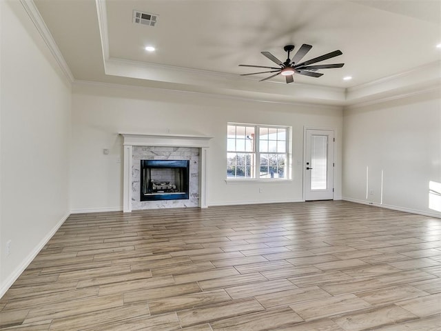 26603 Main St, Blanchard, OK 73010 - unfurnished living room featuring a raised ceiling, crown molding, a ceiling fan, light wood-style floors, and recessed lighting