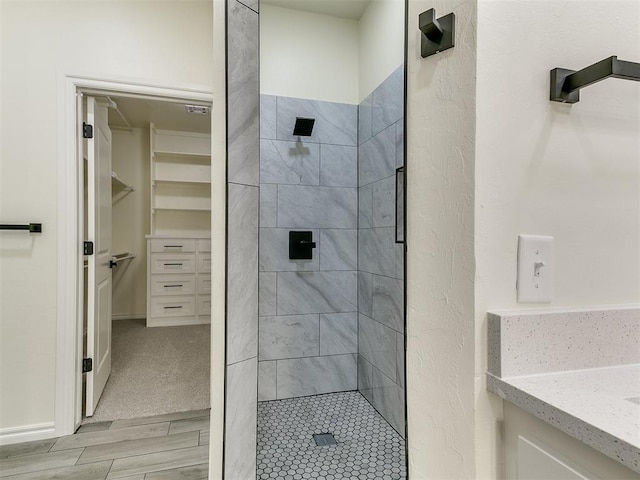 26603 Main St, Blanchard, OK 73010 - full bath with a stall shower, a spacious closet, vanity, and wood finished floors