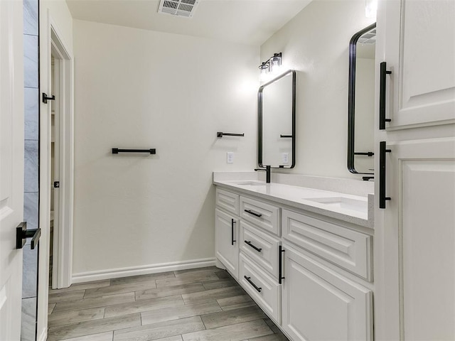 26603 Main St, Blanchard, OK 73010 - full bathroom featuring double vanity, wood finished floors, and baseboards